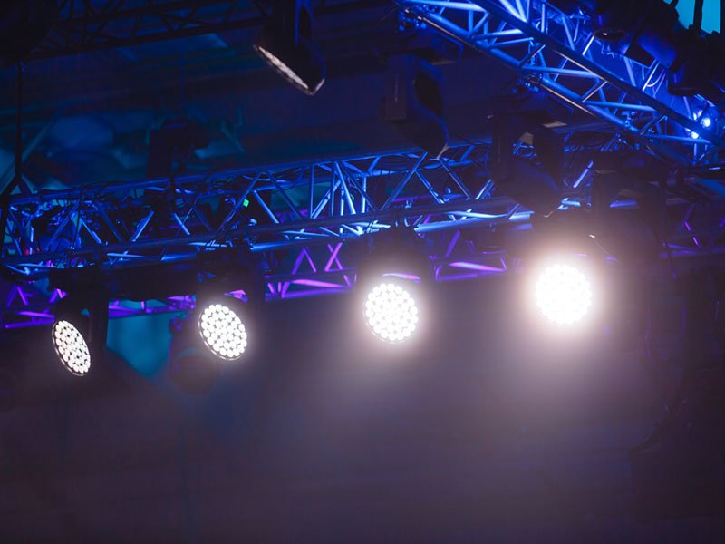 row of stage lights, dark blue background, stage spotlights